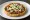 Picada: an illustration of beans, salsa, onion, cheese and more.