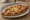 Pide: an illustration of cheese, egg, onion, tomato and more on pita.