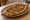 Pide (Turkish): an illustration of lamb, beef, onion, tomato and more on pita.