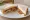 Pilchard Sandwich: an illustration of butter and pepper on white bread.