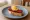 Pintxo de Chistorra con Huevo de Codorniz: an illustration of pork and olive oil on baguette.