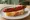 Pintxo de Txistorra: an illustration of pork on baguette.