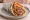 Pita Gyros (Thessaloniki): an illustration of pork, tomato, onion, tzatziki and more on pita.