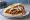 Pita Shoarma: an illustration of lamb, beef, chicken, tomato and more on pita.