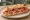 Pizza Bianca con Prosciutto: an illustration of prosciutto and olive oil.