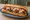 Pizza Steak: an illustration of beef, mozzarella and marinara on hoagie roll.
