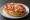 Pizzabrötchen: an illustration of pork, marinara, cheese and tomato on kaiser roll.