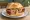 Pizzaleberkäse Semmel: an illustration of pork, beef, pepper, olives and more.