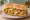 Po' Boy (Oyster): an illustration of oyster, lettuce, tomato, pickle and more on baguette.