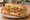 Po' Boy (Soft Shell Crab): an illustration of lettuce, tomato, pickle and mayonnaise on baguette.