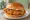 Popeyes Classic Chicken Sandwich: an illustration of chicken, pickle and mayonnaise on burger bun.