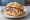 Porchetta di Ariccia: an illustration of pork, garlic, rosemary and pepper on kaiser roll.