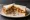 Pork Scratching Sandwich: an illustration of pork and butter on white bread.