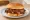 Pork Steak Sandwich: an illustration of pork on burger bun.