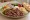Porsiyon Döner: an illustration of beef, lettuce, tomato and onion on bread.