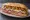 Providence Grinder: an illustration of ham, salami, provolone, lettuce and more on hoagie roll.