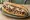 Provolone Wit: an illustration of beef, provolone and onion on hoagie roll.