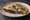 Quesadilla de Huitlacoche: an illustration of corn, onion, garlic and queso oaxaca on tortilla.