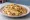 Quesadilla de Pollo: an illustration of chicken, queso oaxaca and onion on tortilla.