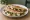 Quesadilla de Rajas: an illustration of queso oaxaca, sour cream and onion on tortilla.