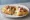 Quesadilla Frita: an illustration of queso oaxaca and olive oil on tortilla.