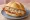 Rahmschnitzel Brötchen: an illustration of pork on kaiser roll.