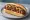 Reindeer Sausage Sandwich: an illustration of pork, onion and mustard on hot dog bun.