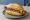 Rindswurst: an illustration of beef, sausage and mustard on kaiser roll.