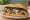 Roast Pork with Spinach: an illustration of pork, provolone, spinach and garlic on hoagie roll.