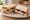 Roast Turkey Sandwich: an illustration of turkey, cranberry sauce, stuffing and mayonnaise on white bread.