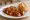 Ruhrpott Currywurst: an illustration of curry powder on kaiser roll.