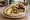 Sabich (סביח): an illustration of eggplant, egg, hummus, tahini and more on pita.