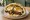 Sabich with Extra Egg (סביח עם ביצה נוספת): an illustration of eggplant, egg, hummus, tahini and more on pita.