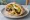 Sabich with Potato (סביח עם תפוח אדמה): an illustration of eggplant, egg, potato, hummus and more on pita.