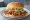 Sacramento Squeeze Burger: an illustration of beef, cheddar cheese, pickle, onion and more on burger bun.