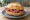 Salami Brötchen: an illustration of salami, butter and mustard on kaiser roll.