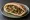 Salat b'Pita (סלט בפיתה): an illustration of tomato, cucumber, onion, parsley and more on pita.