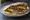 Samak Makli (سمك مقلي): an illustration of fish, lemon, garlic, tahini and more on pita.
