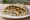 Samak Meshwi (سمك مشوي): an illustration of fish, lemon, garlic, olive oil and more on pita.