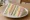 Samsaek Sandwich (삼색 샌드위치): an illustration of ham, egg, cucumber, mayonnaise and more on white bread.