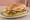 Sandwich (Σάντουιτς): an illustration of pork, tomato, lettuce and cheese on bread.