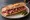 Sandwich à la Coppa: an illustration of capicola, butter and pickle on baguette.