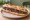 Sandwich à la Tapenade: an illustration of olives, anchovy, caper, garlic and more on baguette.
