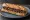 Sandwich Anchoïade: an illustration of anchovy, olive oil, garlic, caper and more on baguette.