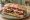 Sandwich Antipasti: an illustration of mozzarella, capicola, artichoke, roasted red pepper and more on ciabatta.