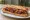 Sandwich au Boudin Basque: an illustration of pork and onion on baguette.