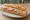 Sandwich au Cervelas: an illustration of pork, horseradish and onion on baguette.