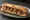 Sandwich au Confit de Canard: an illustration of duck, caramelized onion, pickle and mustard on baguette.