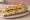 Sandwich au Poulet de Loué: an illustration of chicken, butter, lettuce and mayonnaise on baguette.