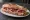Sandwich au Prisuttu: an illustration of pork, butter and pickle.